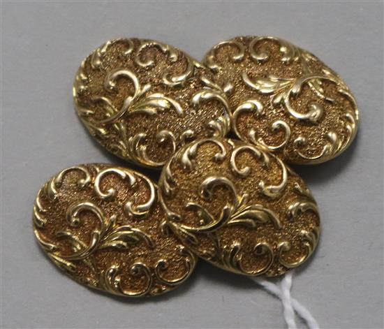 A pair of 15ct gold oval cufflinks, decorated with scrolls, 11.2 grams.